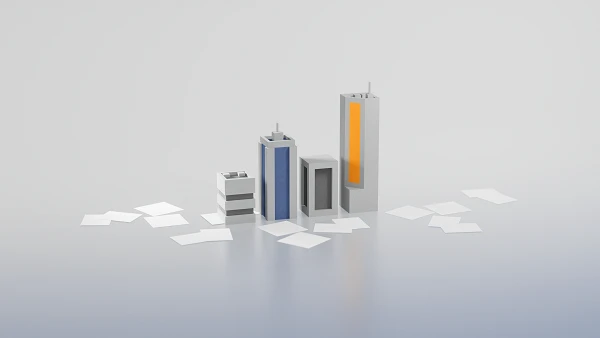 Drei stilisierte Gebäude in verschiedenen Höhen und Farben (blau, orange und grau) stehen auf einer flachen Oberfläche, umgeben von weißen Blättern.